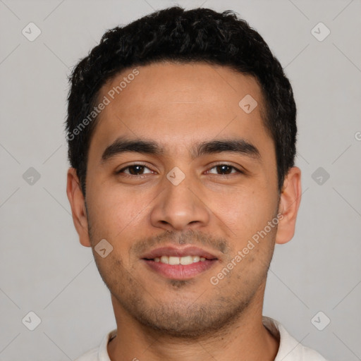 Joyful latino young-adult male with short  black hair and brown eyes