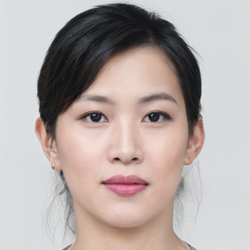Joyful asian young-adult female with medium  black hair and brown eyes