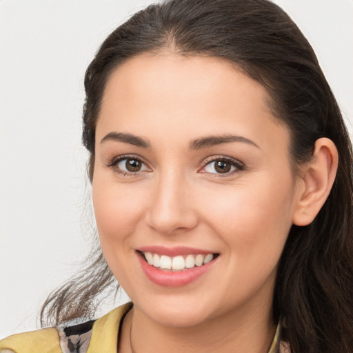 Joyful white young-adult female with long  brown hair and brown eyes