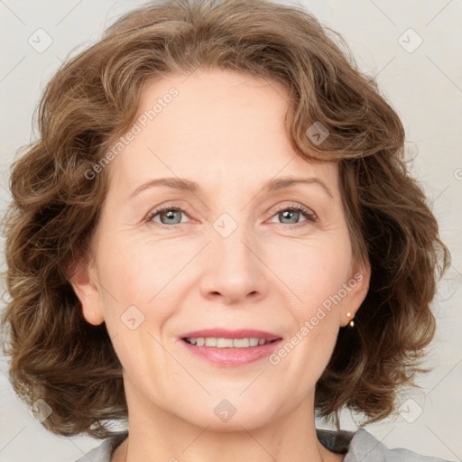 Joyful white adult female with medium  brown hair and blue eyes