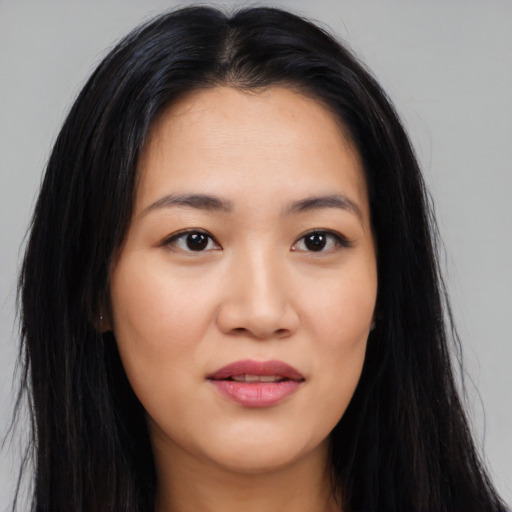 Joyful latino young-adult female with long  black hair and brown eyes