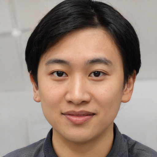 Joyful asian young-adult male with short  black hair and brown eyes