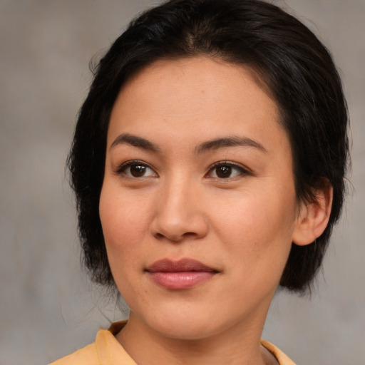 Joyful asian young-adult female with medium  brown hair and brown eyes