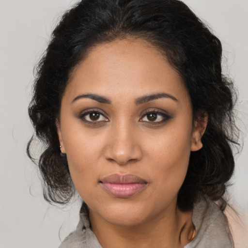 Joyful latino young-adult female with long  brown hair and brown eyes