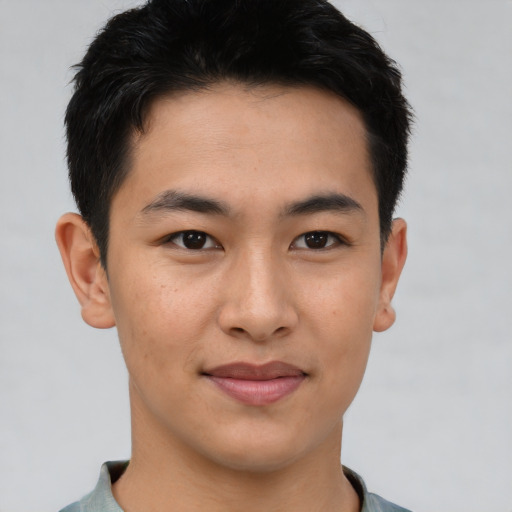 Joyful asian young-adult male with short  brown hair and brown eyes