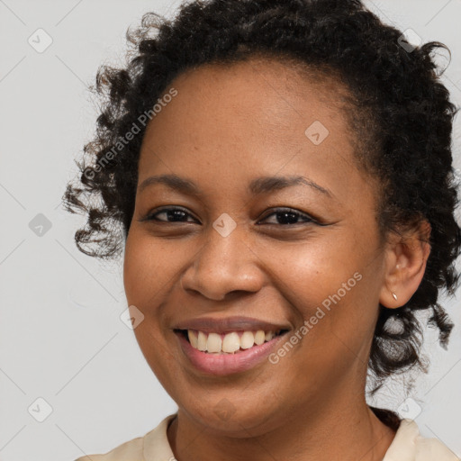 Joyful black young-adult female with short  brown hair and brown eyes