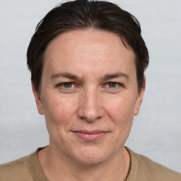 Joyful white adult male with short  brown hair and grey eyes