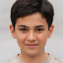 Joyful white child male with short  brown hair and brown eyes