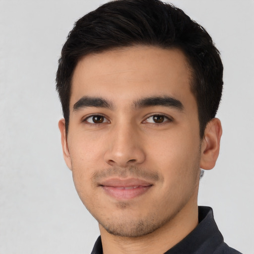 Joyful latino young-adult male with short  black hair and brown eyes