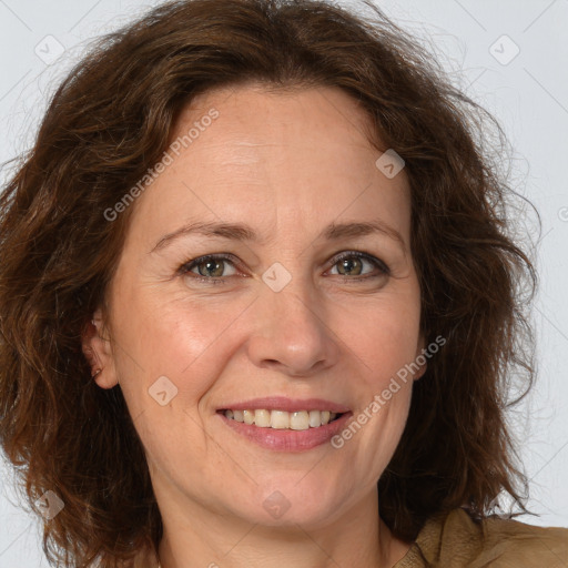 Joyful white adult female with medium  brown hair and green eyes