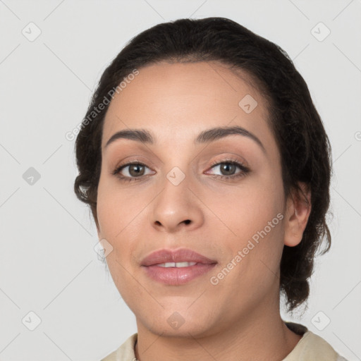 Joyful white young-adult female with medium  black hair and brown eyes