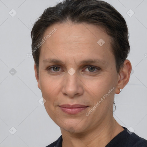 Joyful white adult female with short  brown hair and brown eyes