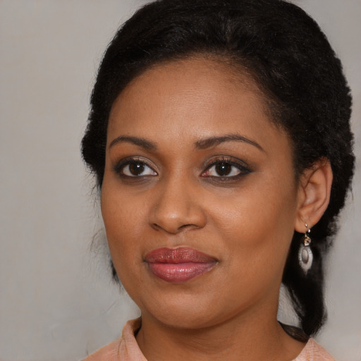 Joyful black young-adult female with medium  brown hair and brown eyes