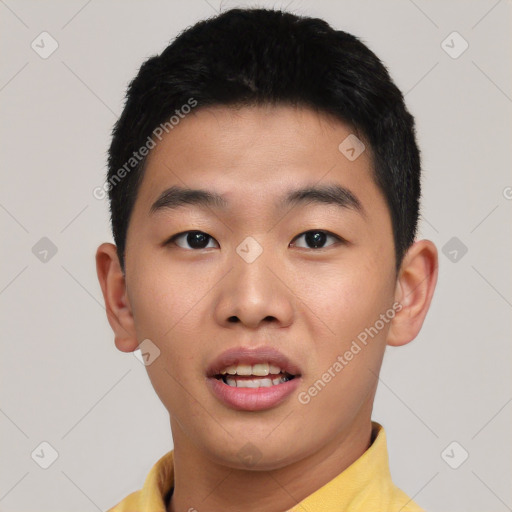 Joyful asian young-adult male with short  black hair and brown eyes