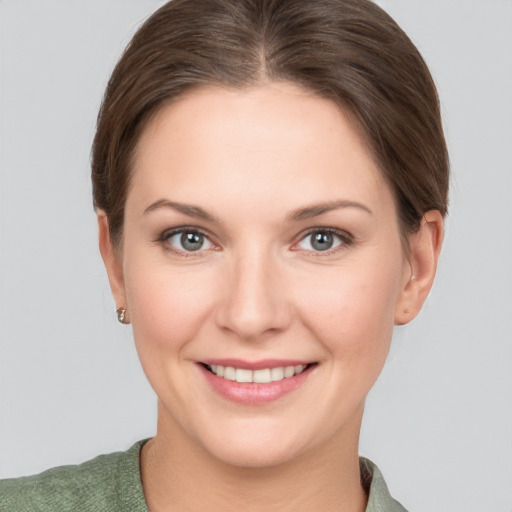 Joyful white young-adult female with short  brown hair and grey eyes