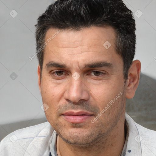 Joyful white adult male with short  black hair and brown eyes