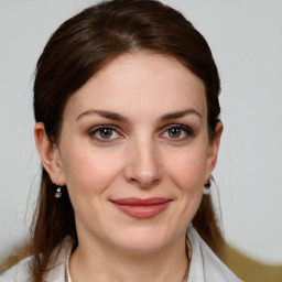 Joyful white young-adult female with medium  brown hair and grey eyes