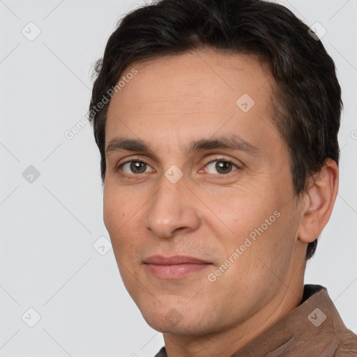 Joyful white adult male with short  brown hair and brown eyes