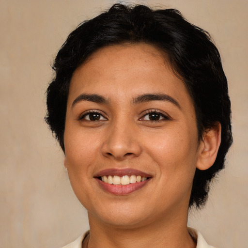 Joyful latino young-adult female with short  brown hair and brown eyes