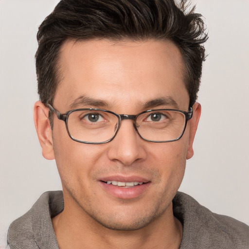 Joyful white adult male with short  brown hair and brown eyes