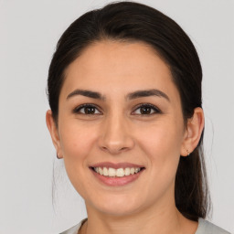 Joyful white young-adult female with medium  brown hair and brown eyes