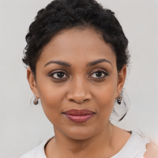Joyful latino young-adult female with short  black hair and brown eyes