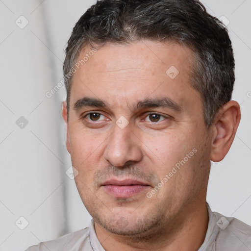 Joyful white adult male with short  brown hair and brown eyes