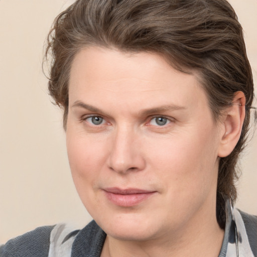 Joyful white adult female with medium  brown hair and grey eyes