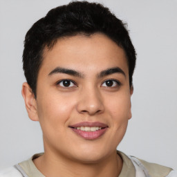 Joyful latino young-adult male with short  brown hair and brown eyes