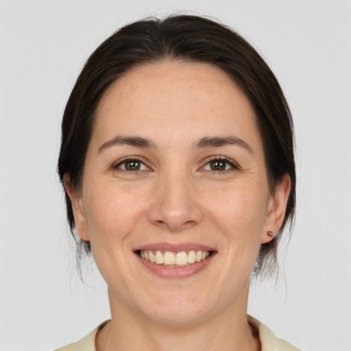 Joyful white young-adult female with medium  brown hair and brown eyes