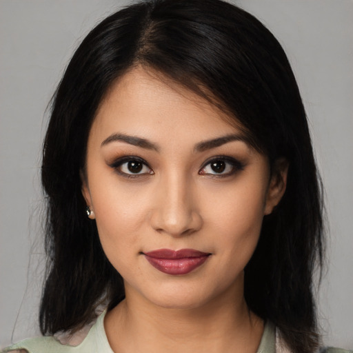 Joyful latino young-adult female with medium  black hair and brown eyes