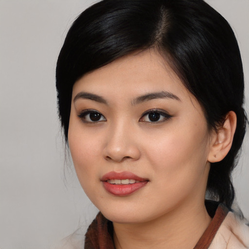Joyful asian young-adult female with medium  black hair and brown eyes
