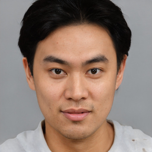 Joyful asian young-adult male with short  black hair and brown eyes