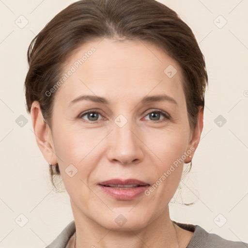 Joyful white adult female with short  brown hair and grey eyes