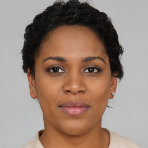 Joyful black young-adult female with short  brown hair and brown eyes