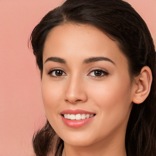 Joyful white young-adult female with long  brown hair and brown eyes