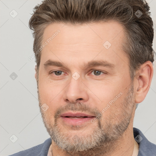 Joyful white adult male with short  brown hair and brown eyes