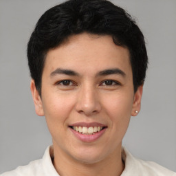 Joyful latino young-adult male with short  brown hair and brown eyes