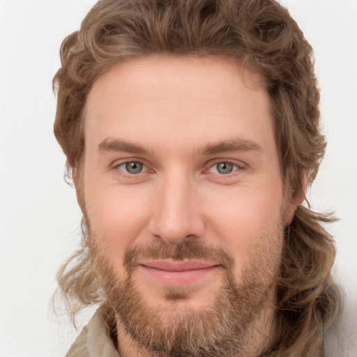 Joyful white young-adult male with short  brown hair and green eyes