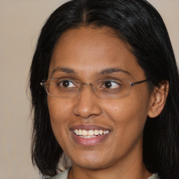 Joyful asian adult female with medium  brown hair and brown eyes