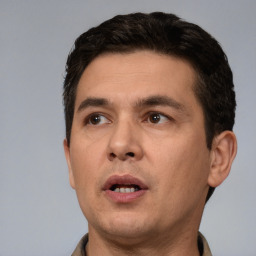 Neutral white young-adult male with short  black hair and brown eyes