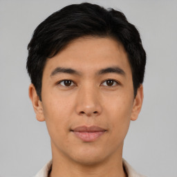 Joyful asian young-adult male with short  black hair and brown eyes