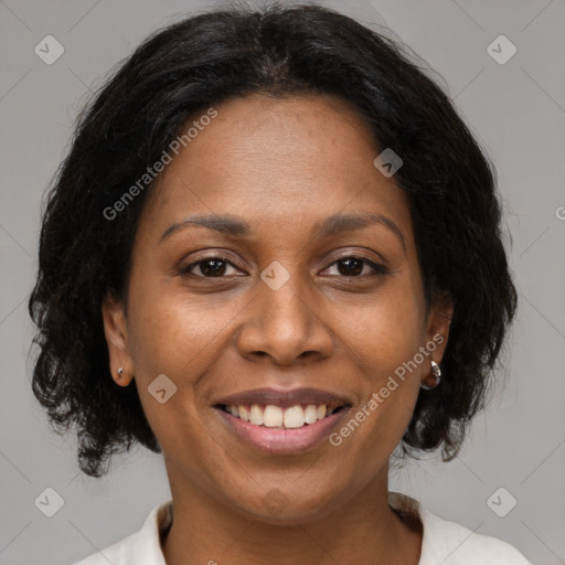 Joyful black adult female with medium  brown hair and brown eyes