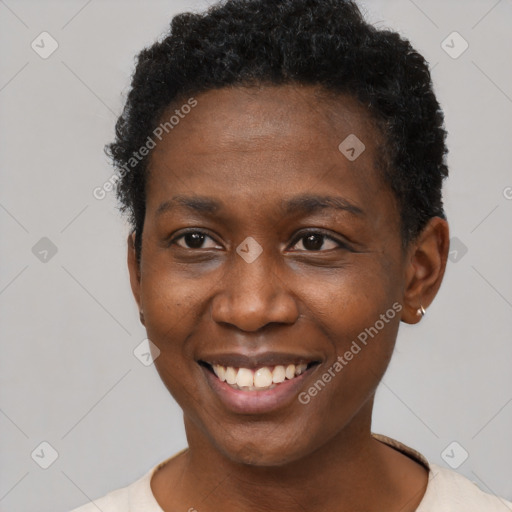 Joyful black young-adult female with short  brown hair and brown eyes