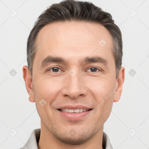 Joyful white young-adult male with short  brown hair and brown eyes