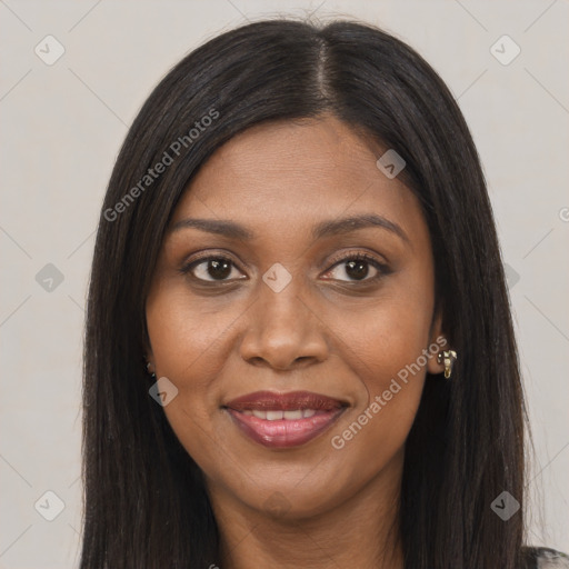 Joyful black young-adult female with long  brown hair and brown eyes