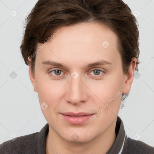 Joyful white young-adult female with short  brown hair and grey eyes