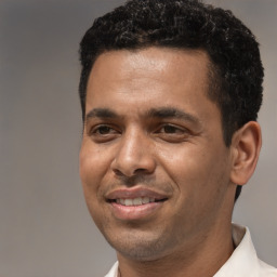 Joyful latino adult male with short  black hair and brown eyes