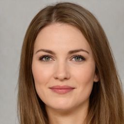 Joyful white young-adult female with long  brown hair and green eyes