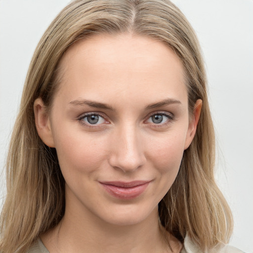 Joyful white young-adult female with long  brown hair and blue eyes